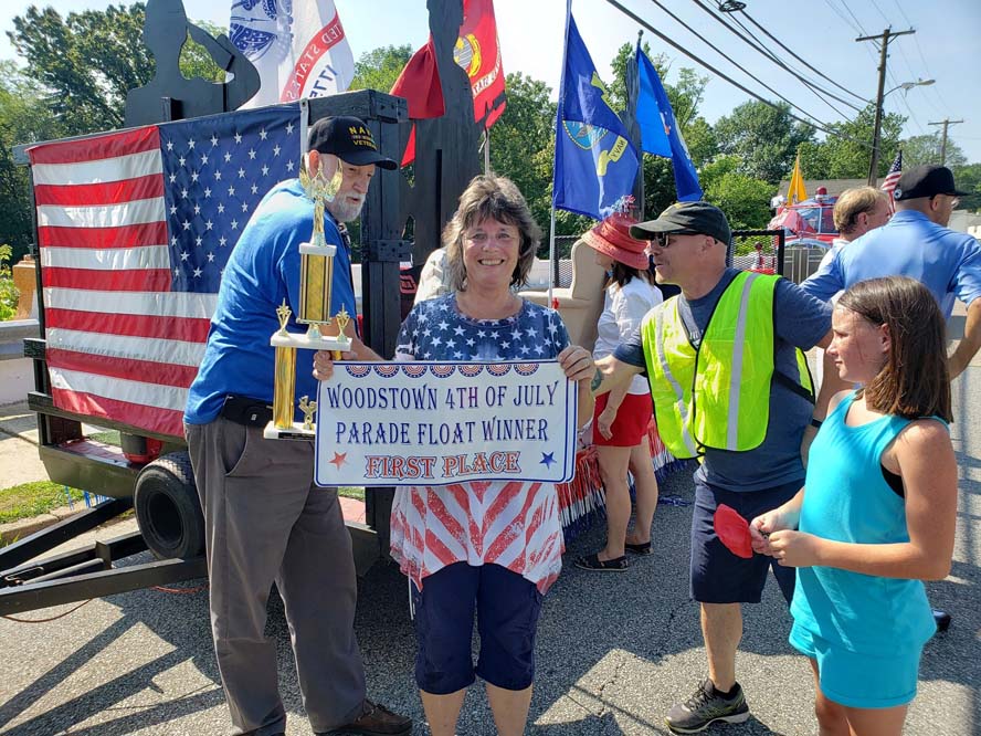 Woman holding 1st place winner banner for Woodstown 4th of July