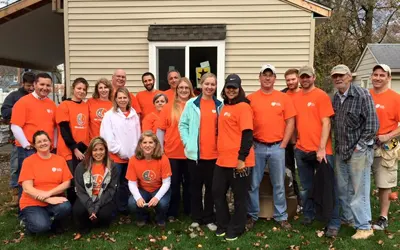 Volunteers standig in front of recently completed house